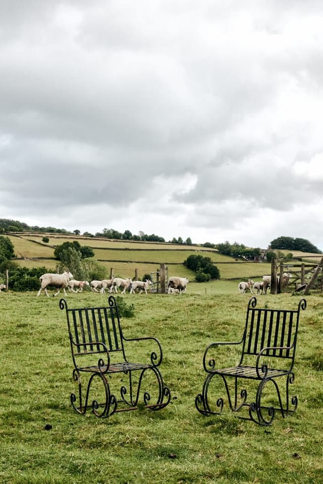 A Pair of Elegant Antique Rocking Chairs in Wrought Iron