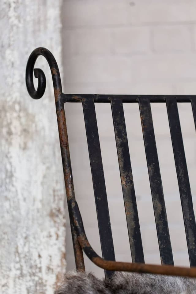 A Pair of Elegant Antique Rocking Chairs in Wrought Iron