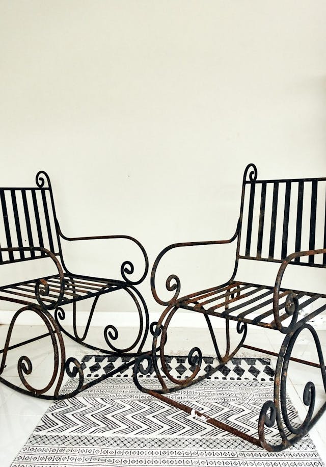 A Pair of Elegant Antique Rocking Chairs in Wrought Iron